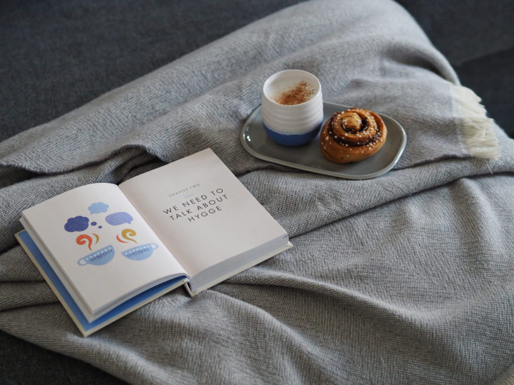 Ingrid of That Scandinavian Feeling snuggles up with a warm drink, treat, good book and blanket.